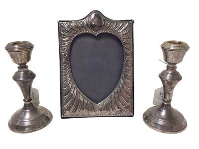 Lot 256 - Contemporary silver photograph frame, with embossed decoration and a pair of candlesticks