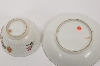 Lot 67 - Derby ribbed tea bowl and saucer, painted with flowers, circa 1758