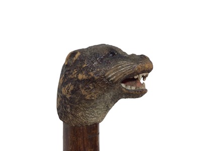 Lot 942 - Rare carved otter pole by Swaine & Adeney, London, the ash tree shaft terminating in a metal spike