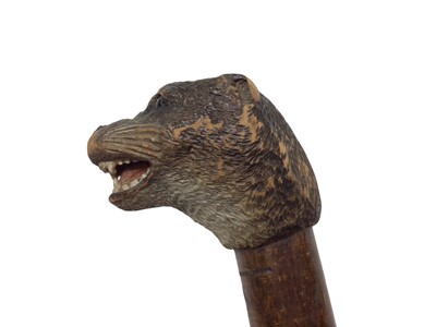 Lot 942 - Rare carved otter pole by Swaine & Adeney, London, the ash tree shaft terminating in a metal spike