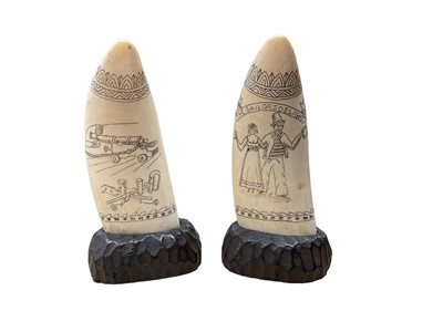 Lot 80 - Pair of scrimshaw whale's teeth mounted on wooden bases, 19th century style but later