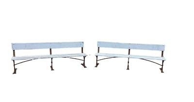 Lot 1394 - Large pair of antique wrought iron and slatted benches, 225cm wide