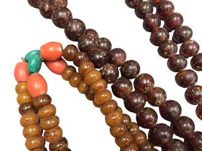 Lot 1030 - Two large Tibetan simulated and reconstituted amber prayer bead necklaces