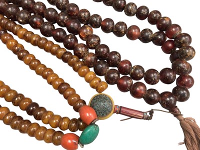Lot 1030 - Two large Tibetan simulated and reconstituted amber prayer bead necklaces