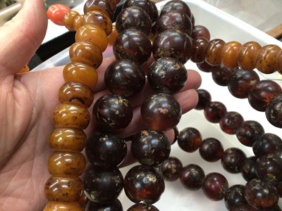 Lot 1030 - Two large Tibetan simulated and reconstituted amber prayer bead necklaces