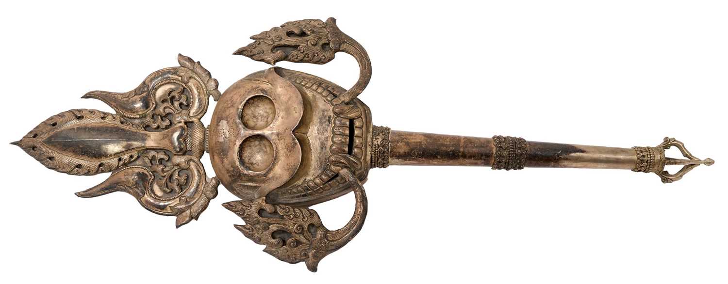 Lot 945 - Antiquei Tibetan ceremonial staff, with stylised skull ornament, 60cm long