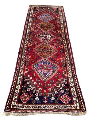 Lot 1389 - Persian runner with five central medallions on red, blue and cream ground