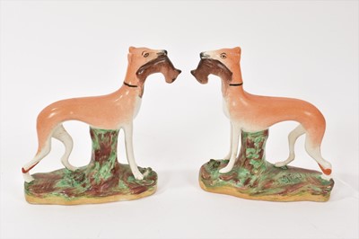 Lot 237 - Pair of Staffordshire pottery models of standing greyhounds