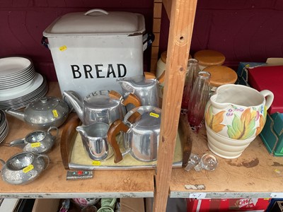 Lot 710 - Enamel bread bin, piquot ware teaset and tray, pewter three piece teaset and Clarice Cliff jug.