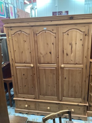 Lot 1325 - Modern pine triple wardrobe with two panelled doors and drawers below 161cm wide, 200cm high, 60cm deep