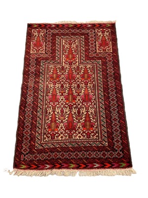 Lot 1366 - Baluch rug with geometric decoration on red ground, 144cm x 93cm