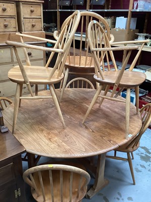 Lot 1326 - Ercol elm oval dropleaf kitchen table opening to 127 x 141cm and seven Ercol stick back chairs comprising four standards and three elbows (8)