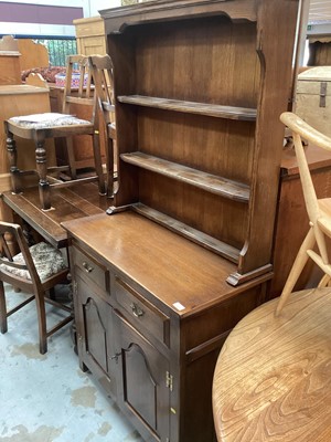 Lot 1327 - Reprodux oak dresser with raised back, two drawers and two panelled doors 173cm high, 92cm wide