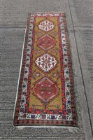 Lot 1545 - Eastern runner, the green ground centred by...