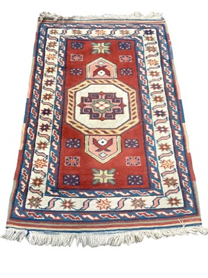 Lot 1371 - Eastern rug with central medallion on red, blue and cream ground, 133cm x 87cm