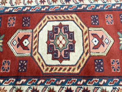 Lot 1371 - Eastern rug with central medallion on red, blue and cream ground, 133cm x 87cm