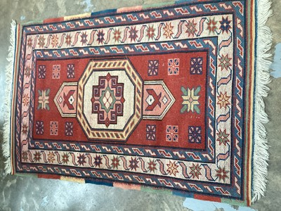 Lot 1371 - Eastern rug with central medallion on red, blue and cream ground, 133cm x 87cm