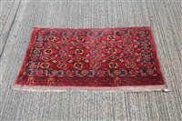 Lot 1546 - Unusual Tekke-style rug, brick-red ground with...