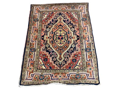 Lot 1376 - Eastern rug with geometric decoration on red, orange, blue and green ground, 97cm x 73cm