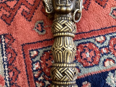 Lot 22 - Tibetan ritual dagger/Phurba in fitted carved wooden case/stand with applied decoration, the case 48cm wide