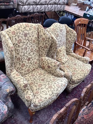 Lot 1385 - Two similar wing back armchairs with yellow floral upholstery