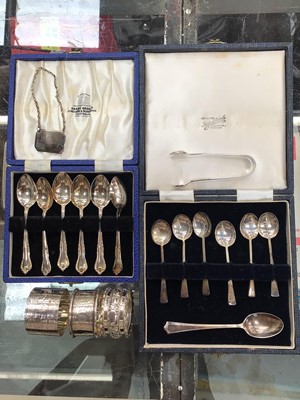 Lot 1036 - Two cased sets of six silver spoons, one other silver teaspoon, pair silver sugar tongs, three silver napkin rings and a silver whiskey label