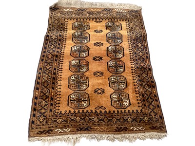 Lot 1391 - Eastern rug with twelve medallions on rust brown ground, 120cm x 89cm