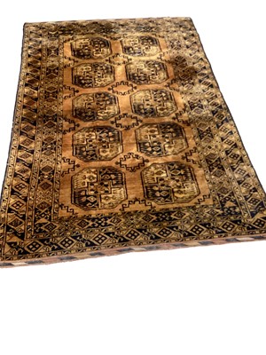 Lot 1393 - Eastern rug with ten medallions on rust brown ground, 212cm x 138cm