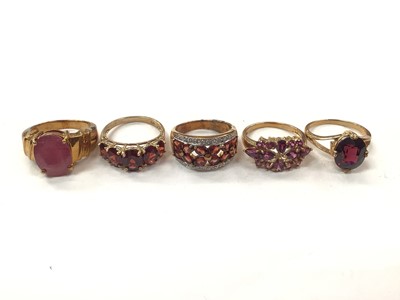 Lot 1043 - Five 9ct gold pink and red gem set dress ring