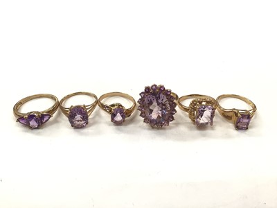 Lot 1046 - Six 9ct gold purple gem set dress rings