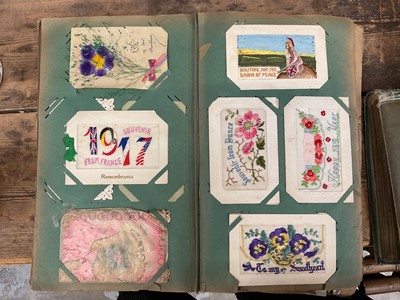 Lot 1400 - Three large and two small albums of postcards, autograph album and some embroidered textiles.