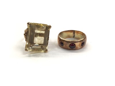 Lot 1062 - 1970s 9ct gold citrine cocktail ring and a 1920s 9ct rose gold ring set with three red cabochons (2)