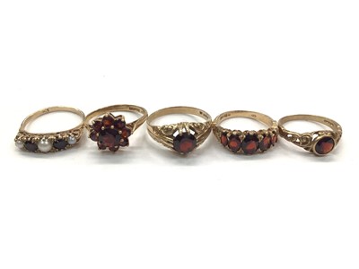 Lot 1064 - 9ct gold garent and seed pearl five stone ring and four other 9ct gold garent rings (5)