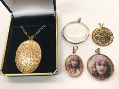 Lot 1065 - 9ct gold oval locket on 9ct gold chain, three 9ct gold mounted glass lockets and a gold plated coin pendant