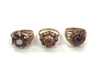 Lot 1067 - 9ct gold opal and garent cluster ring and two other 9ct gold garnet cluster rings (3)