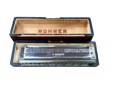 Lot 680 - Hohner Chromonica in fitted case, cigarette cards, postcards, packs of playing cards, two children's books and other items - 1 box