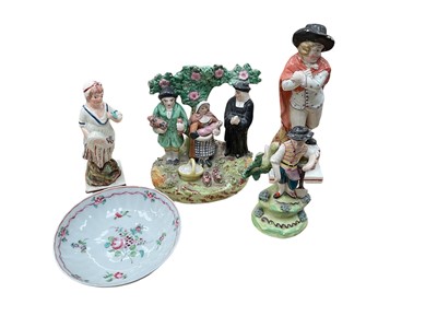 Lot 62 - Group of Staffordshire figures, including a Tithe Pig group and three pearlware figures, and an 18th century Chinese saucer (5)