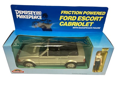 Lot 313 - Rainbow Toys (c1984) Dempsey & Makepeace Friction Powered Mercedes with Dempsey Figure No.DM0110 and Ford Escort Cabriolet with Makepeace Figure No.DM0120, in window boxes (2)