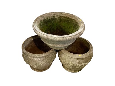 Lot 1424 - Three concrete garden planters, 40cm, 30cm and 40cm high