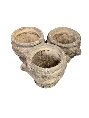 Lot 1427 - Three concrete garden planters with scroll handles, 41cm high, 40cm diameter