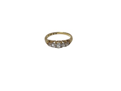 Lot 519 - Victorian diamond five stone ring with five old cut diamonds in carved gold claw setting with scroll shoulders on tapered shank, London 1865. Estimated total diamond weight approximately 0.50cts. R...