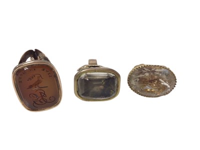 Lot 528 - Georgian seal with intaglio carved carnelian depicting a family crest and motto 'Live in Hope', another with foiled-backed stone and 9ct gold mounted citrine seal (3)