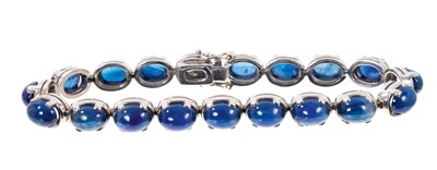 Lot 534 - Cabochon blue sapphire and 18ct white gold bracelet with nineteen blue sapphire oval cabochons in 18ct white gold setting, 18cm