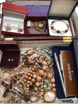 Lot 1097 - Wooden jewellery box containing costume jewellery, pair of silver cufflinks, silver ingot pendant on chain and a silver gilt purple stone bracelet