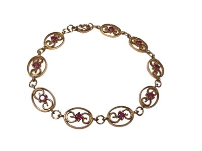 Lot 186 - 9ct gold and ruby bracelet with nine oval panels each set with a round mixed cut ruby