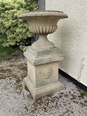 Lot 1550 - Large pair of reconstituted stone garden urms of campagna form with egg and dart rim, reeded bowl on socle bases with square plinths, 122cm high x 72cm diameter