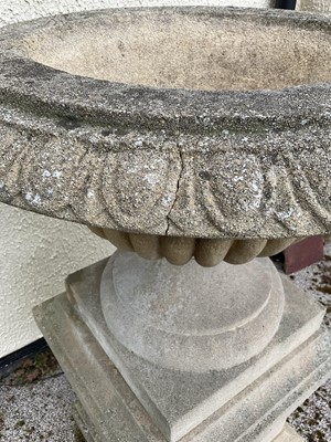 Lot 1550 - Large pair of reconstituted stone garden urms of campagna form with egg and dart rim, reeded bowl on socle bases with square plinths, 122cm high x 72cm diameter