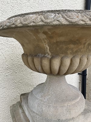 Lot 1550 - Large pair of reconstituted stone garden urms of campagna form with egg and dart rim, reeded bowl on socle bases with square plinths, 122cm high x 72cm diameter