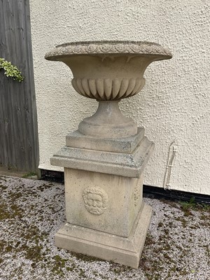 Lot 1550 - Large pair of reconstituted stone garden urms of campagna form with egg and dart rim, reeded bowl on socle bases with square plinths, 122cm high x 72cm diameter