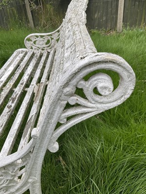 Lot 1556 - Victorian style white painted cast metal garden bench with lily pad and foliate design, 131cm wide.